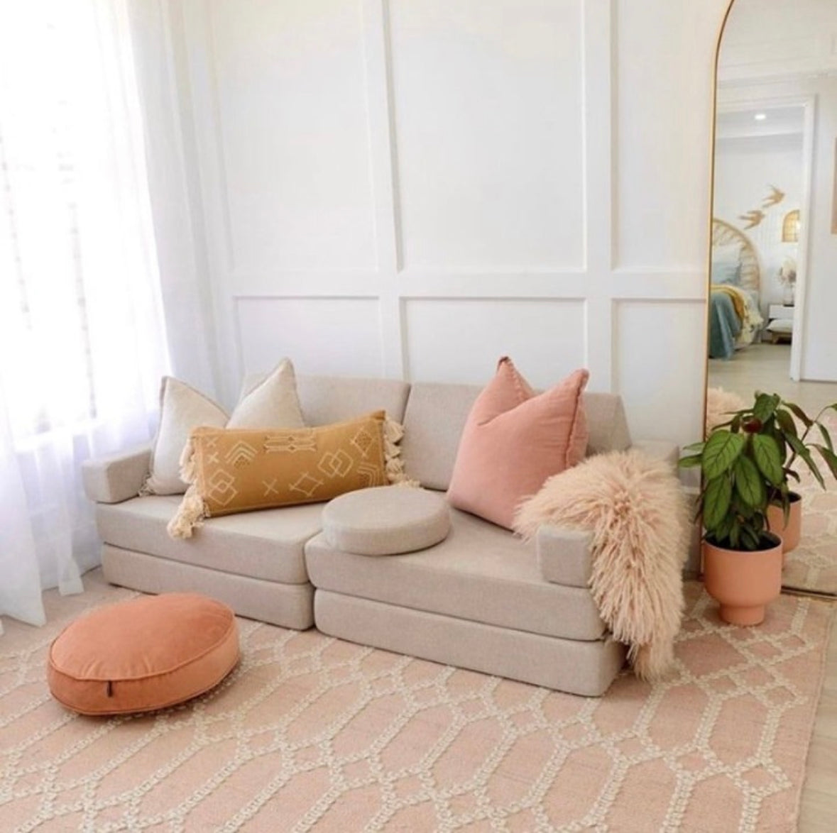 Pink rug styled in living room