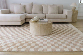 Cream and beige checkered rug styled in a living room — Simple Style Co