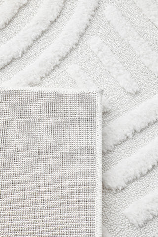 Close-up of textured white rug with patterned border